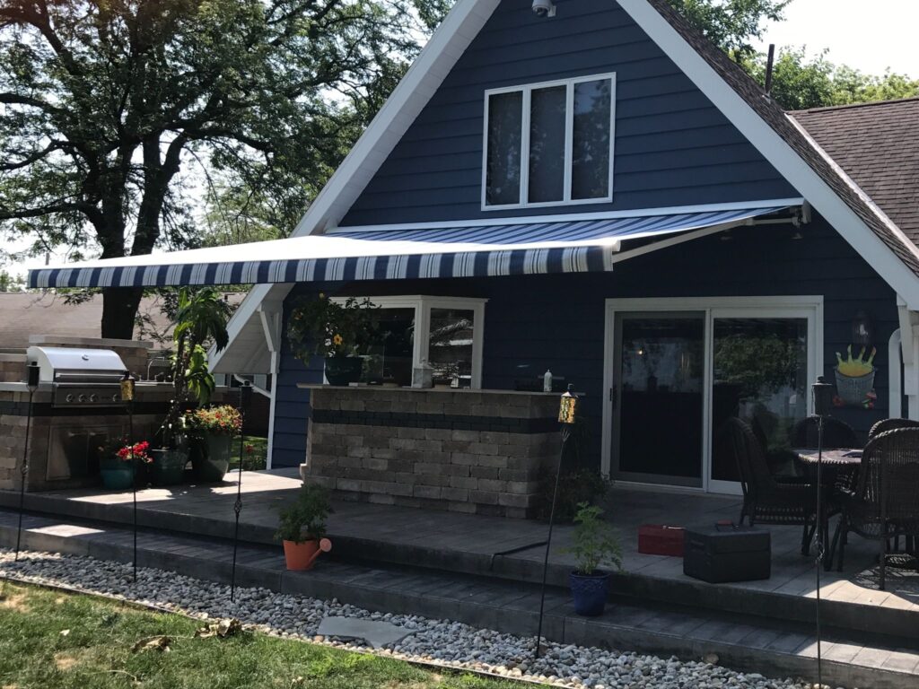 A blue Sunesta awning providing ample shade for a Pennsylvanian backyard patio.